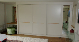 Bespoke sliding door wardrobe in painted tulipwood and oak interior